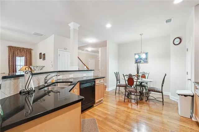 a view of a kitchen with kitchen island dining table and a chandelier