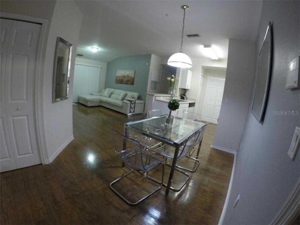 a view of a dining room with furniture and a chandelier