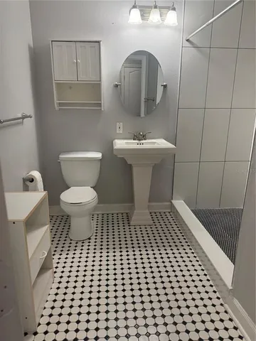 a bathroom with a sink toilet and shower
