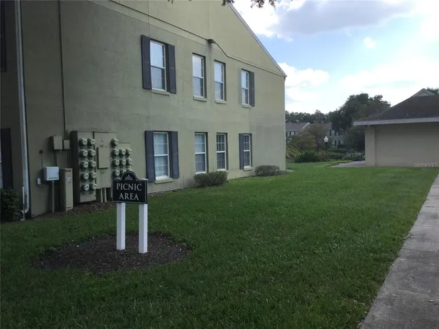 a front view of a house with backyard garden and trees