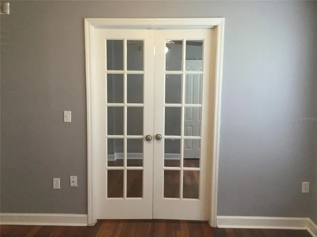 a view of wooden floor with entryway and windows