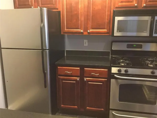 a kitchen with a refrigerator and cabinets