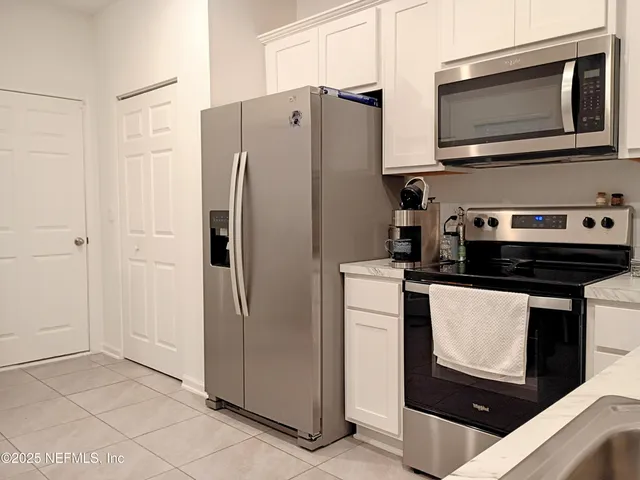 a kitchen with stainless steel appliances a refrigerator stove and microwave