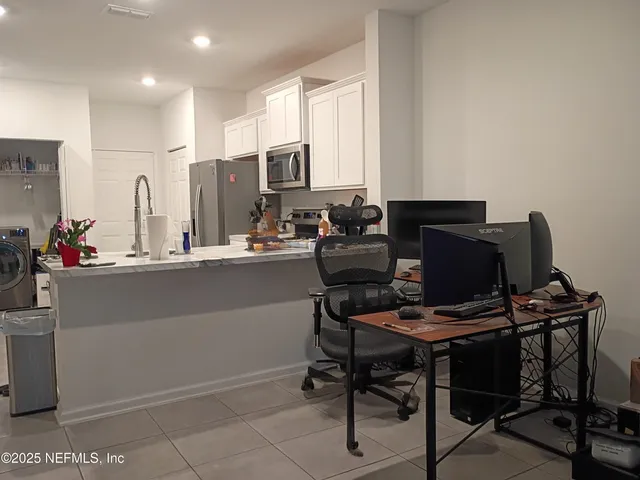 a workspace with furniture and a piano