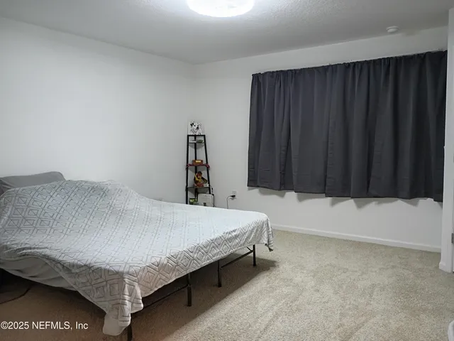 a bedroom with a bed and a cabinet