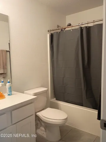 a bathroom with a sink a toilet a shower and a mirror