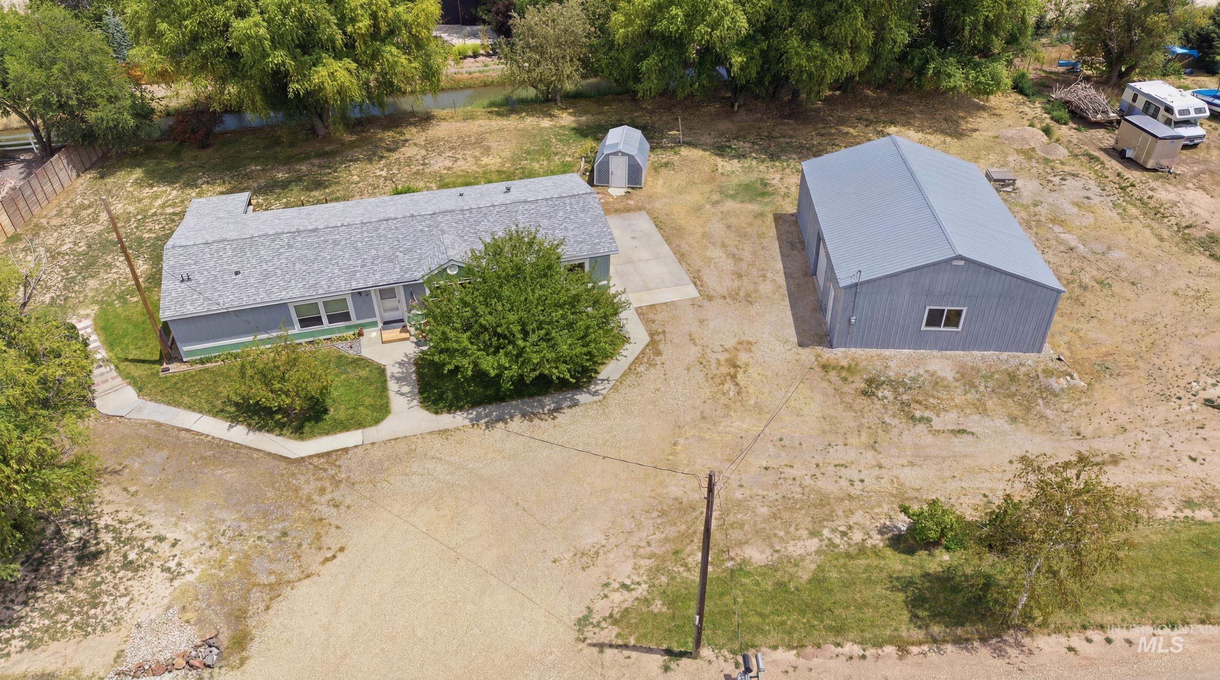 7422 Track Road Nampa, ID 83686 - Photo 3 of 50 Property featuring a single-story residence with a gray shingle roof and light blue siding