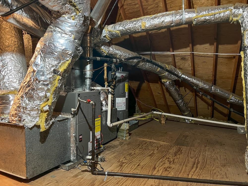 7935 Memphis Arlington Road Bartlett, TN 38133 - Photo 17 of 20 Attic space featuring a furnace unit, extensive insulated ductwork, and exposed wooden rafters
