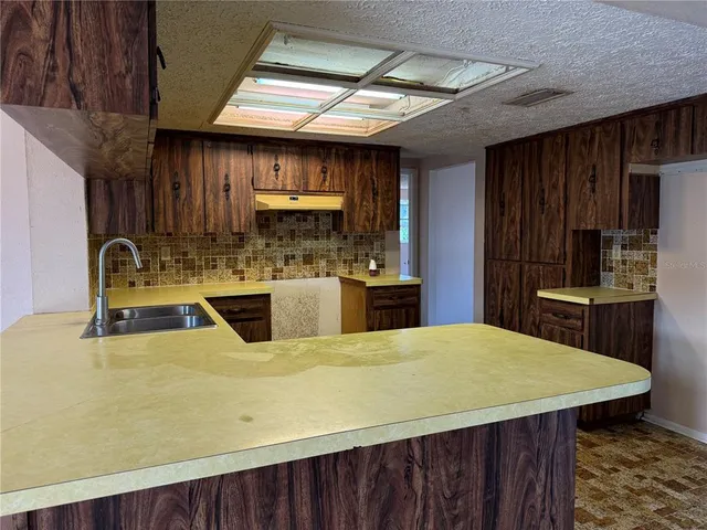 a room with wooden floors and wooden cabinets