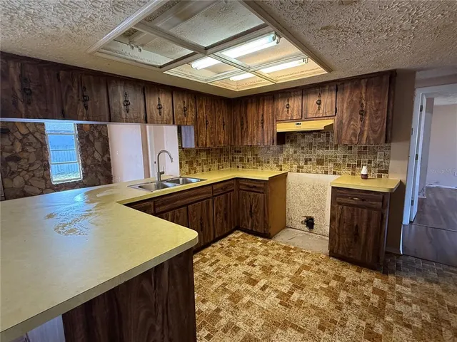 a kitchen with sink cabinets and wooden floor