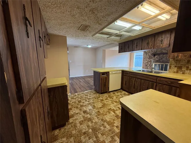 a house with green field in front of it