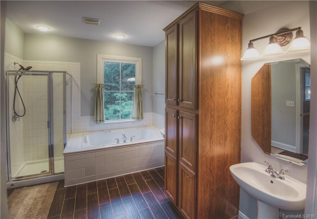 122 Mills Lane Fort Mill, SC 29708 - Photo 14 of 36 a bathroom with a bathtub and a shower