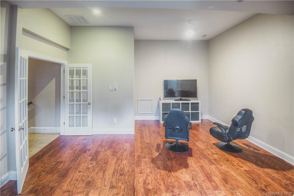 122 Mills Lane Fort Mill, SC 29708 - Photo 20 of 36 a living room with furniture a flat screen tv and a fireplace