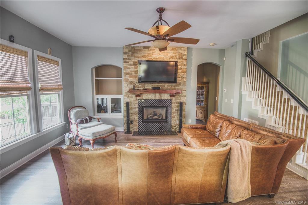 122 Mills Lane Fort Mill, SC 29708 - Photo 3 of 36 a living room with furniture a fireplace and a flat screen tv