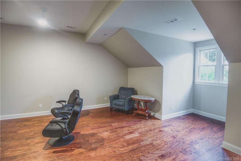 122 Mills Lane Fort Mill, SC 29708 - Photo 23 of 36 a room with wooden floor and furniture