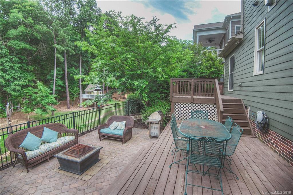 122 Mills Lane Fort Mill, SC 29708 - Photo 30 of 36 a view of a chairs and table on the wooden deck