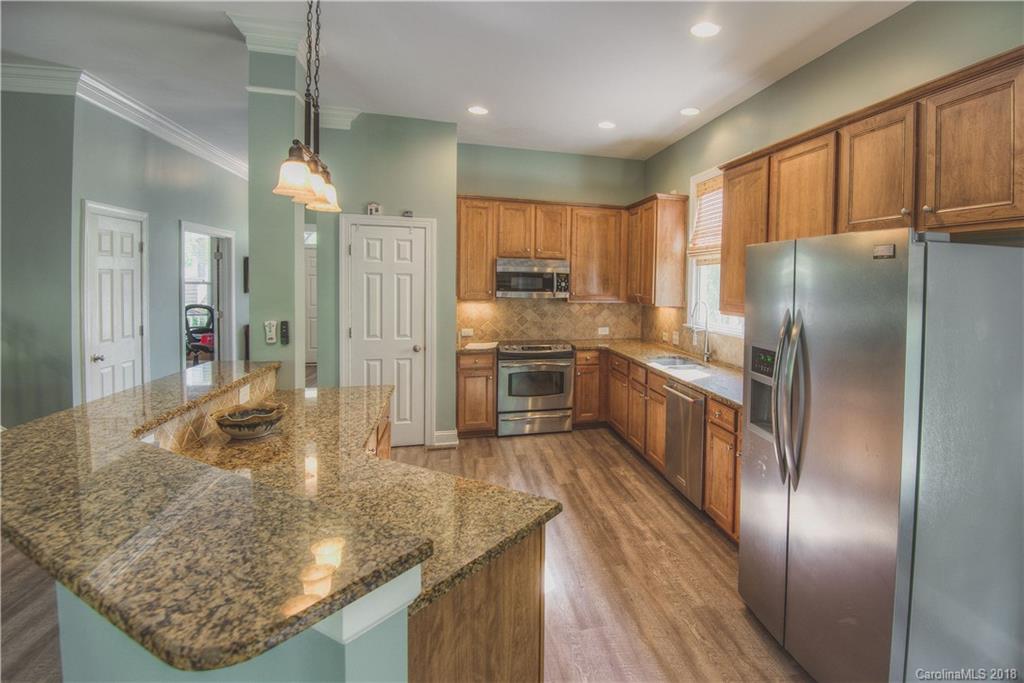 122 Mills Lane Fort Mill, SC 29708 - Photo 7 of 36 a kitchen with stainless steel appliances granite countertop a refrigerator a stove and a sink