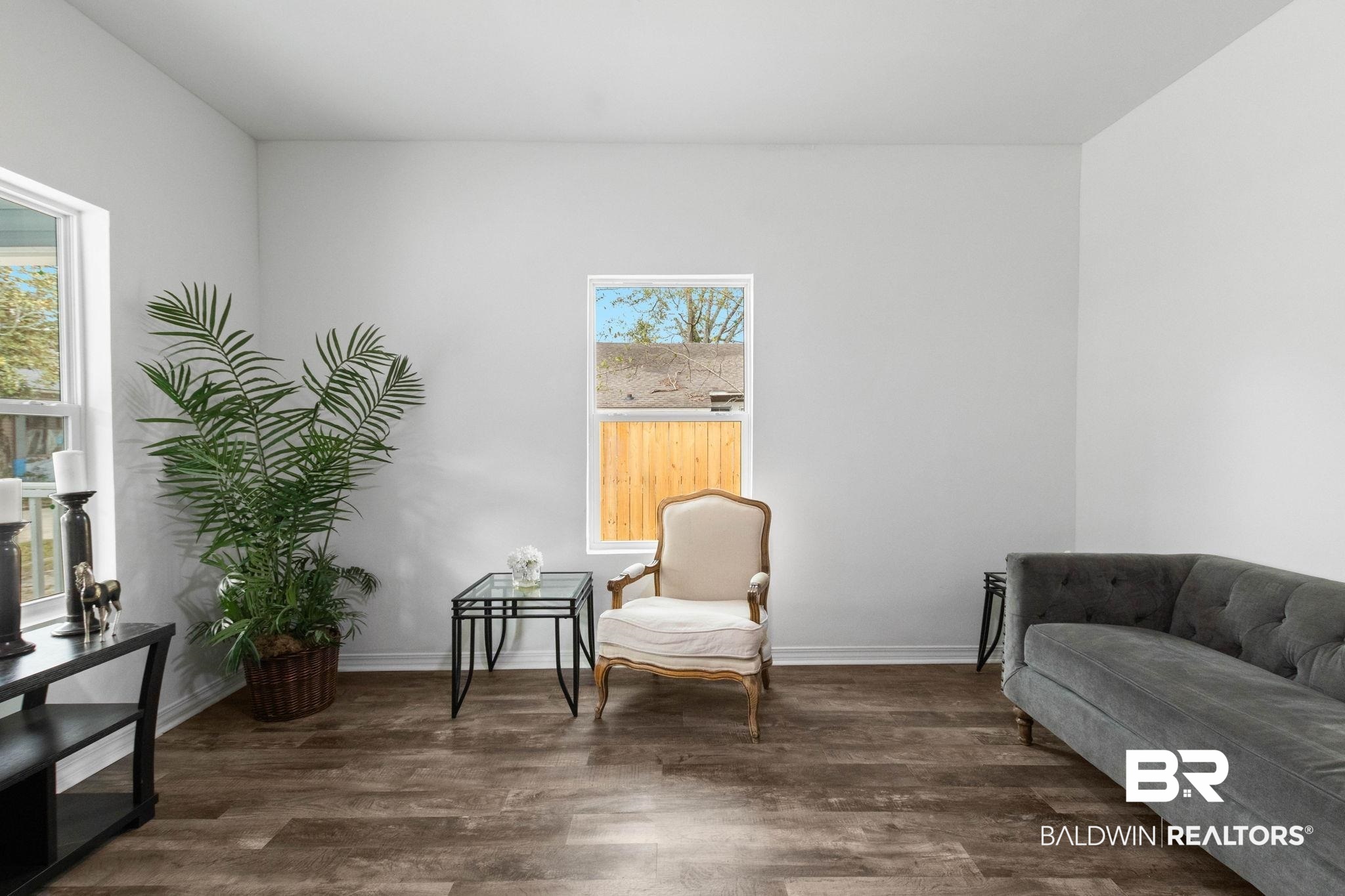 128 Bush Avenue Mobile, AL 36604 - Photo 5 of 40 Living area with dark wood-style flooring and baseboards