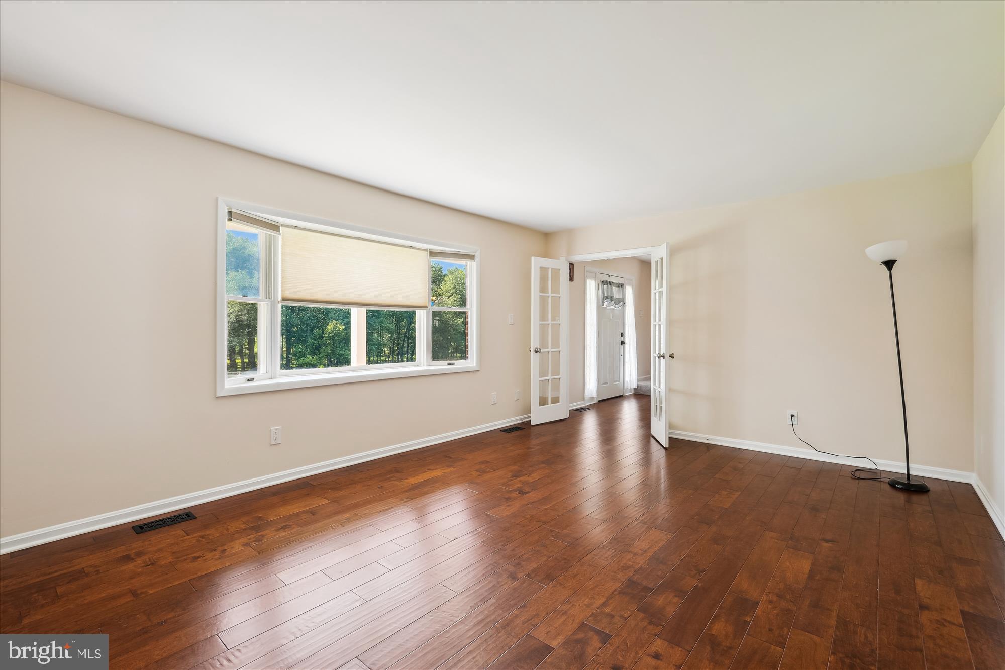 17721 Lisa Drive Derwood, MD 20855 - Photo 14 of 87 a view of an empty room with wooden floor and a window