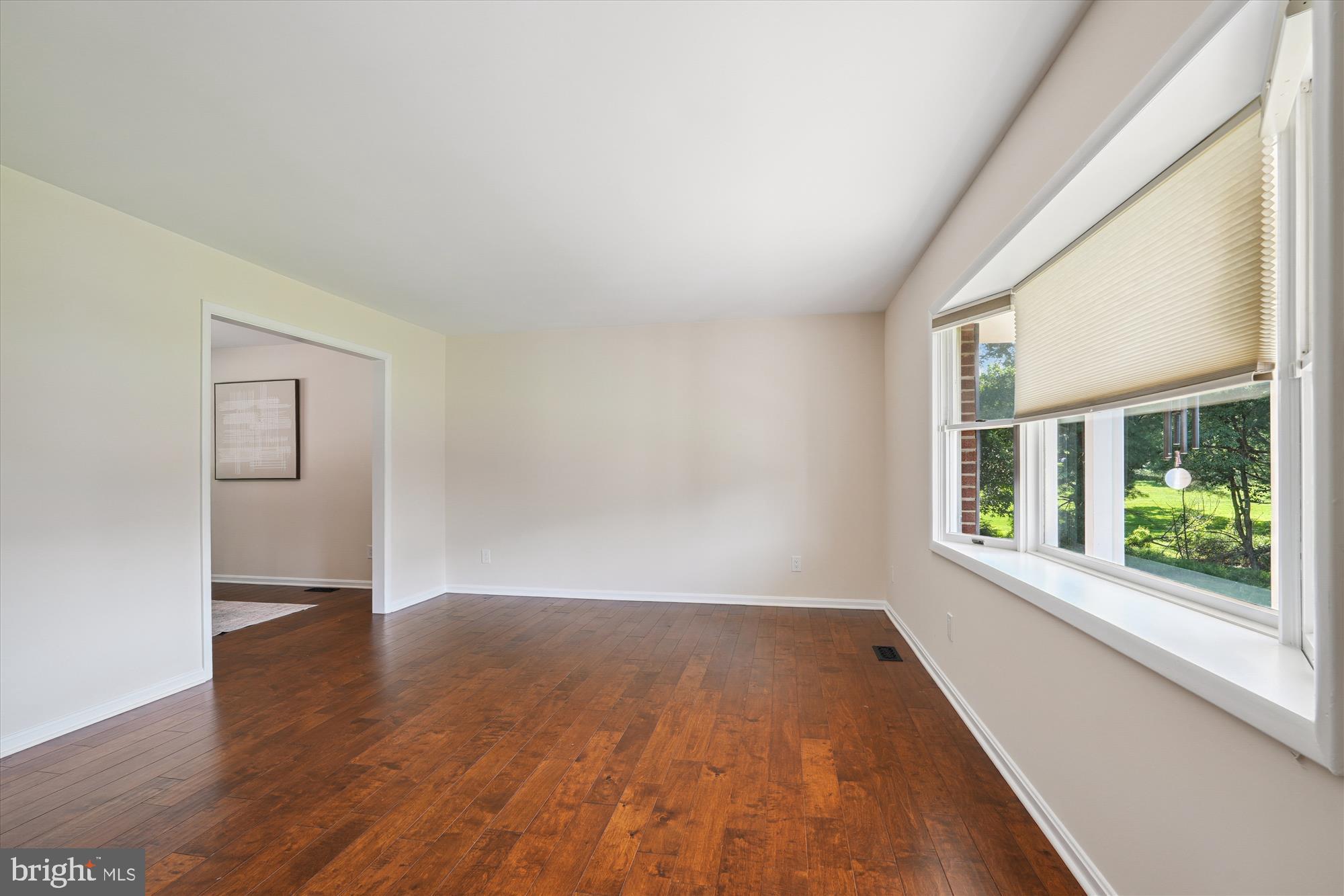 17721 Lisa Drive Derwood, MD 20855 - Photo 16 of 87 a view of an empty room with wooden floor and a window