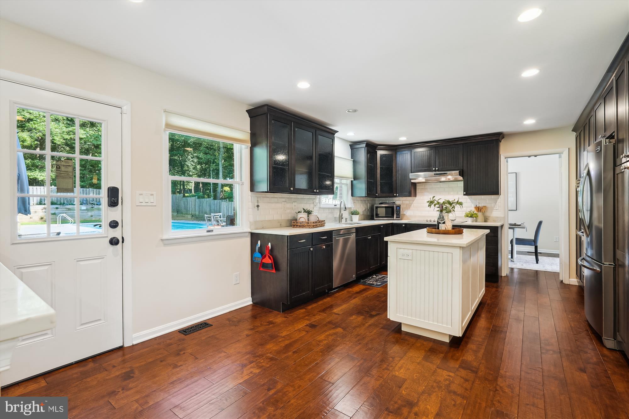 17721 Lisa Drive Derwood, MD 20855 - Photo 24 of 87 a kitchen with a refrigerator a stove top oven a sink dishwasher and wooden cabinets with wooden floor
