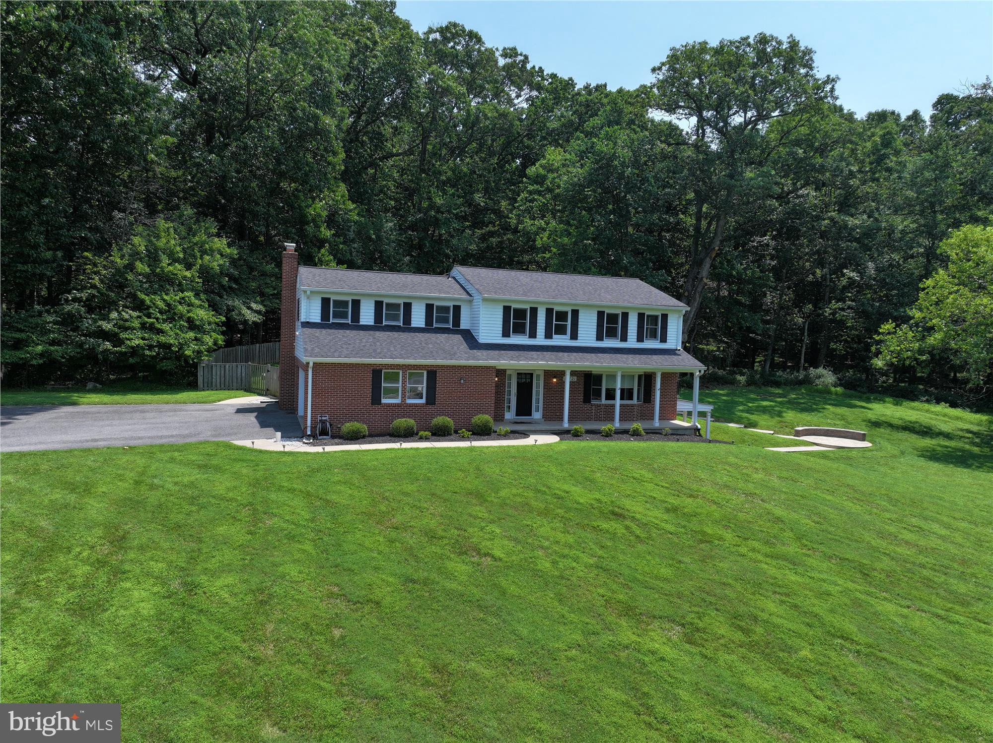 17721 Lisa Drive Derwood, MD 20855 - Photo 3 of 87 a front view of a house with garden and trees