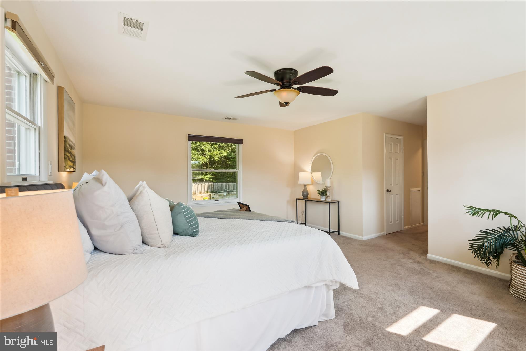 17721 Lisa Drive Derwood, MD 20855 - Photo 34 of 87 a bedroom with a large bed and a chandelier