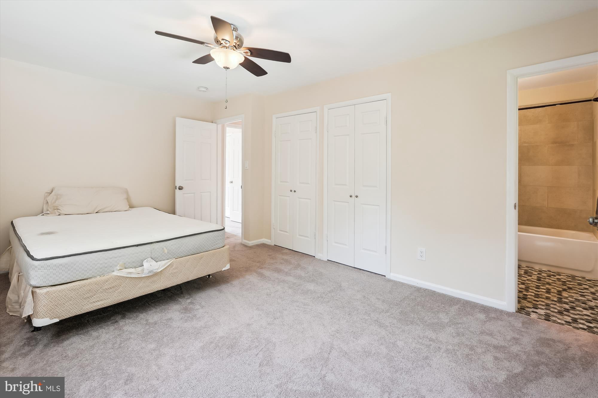 17721 Lisa Drive Derwood, MD 20855 - Photo 48 of 87 a spacious bedroom with a bed and a ceiling fan