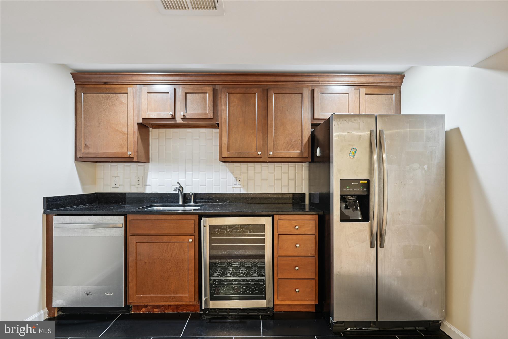 17721 Lisa Drive Derwood, MD 20855 - Photo 53 of 87 a kitchen with granite countertop a refrigerator and cabinets