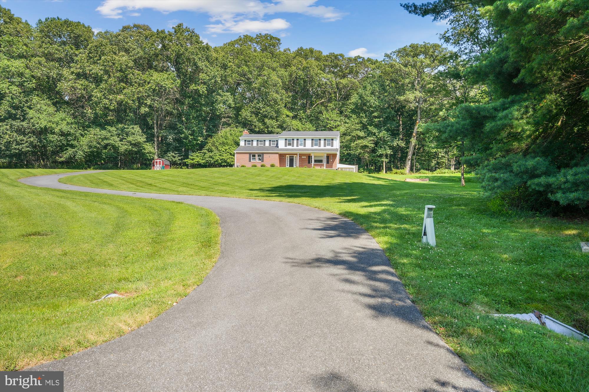 17721 Lisa Drive Derwood, MD 20855 - Photo 70 of 87 a view of a swimming pool with a yard and large trees