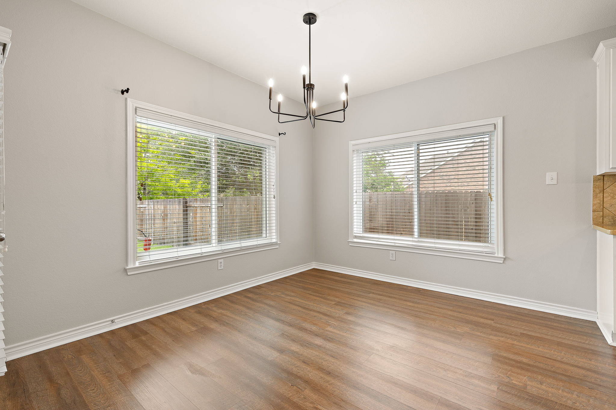 202 Nick Price Loop Round Rock, TX 78664 - Photo 11 of 39 a view of an empty room with a window and wooden floor