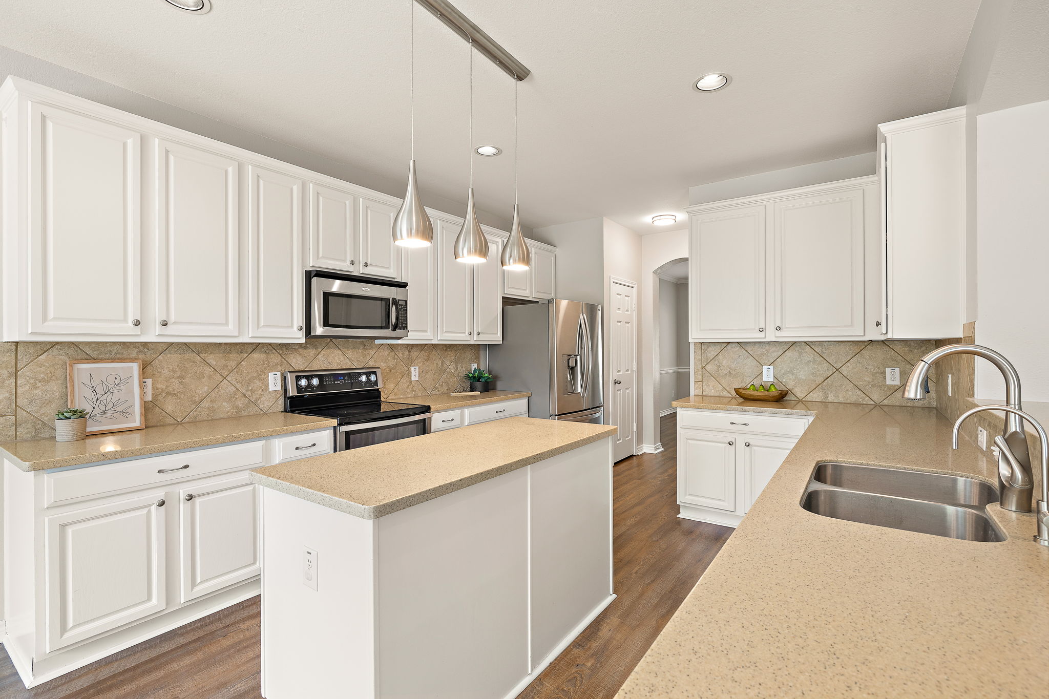 202 Nick Price Loop Round Rock, TX 78664 - Photo 12 of 39 a kitchen with a sink a stove a microwave and cabinets