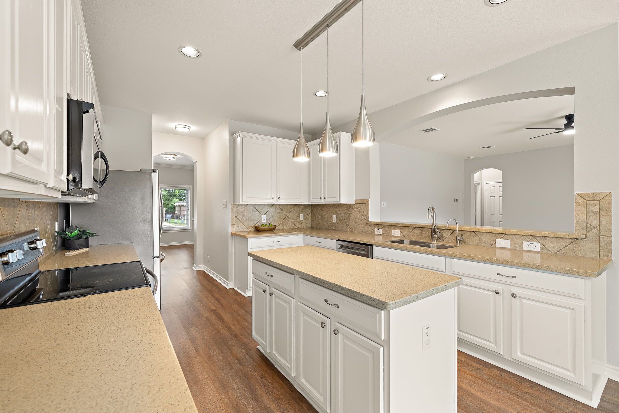 202 Nick Price Loop Round Rock, TX 78664 - Photo 13 of 39 a kitchen with a sink stove cabinets and wooden floor