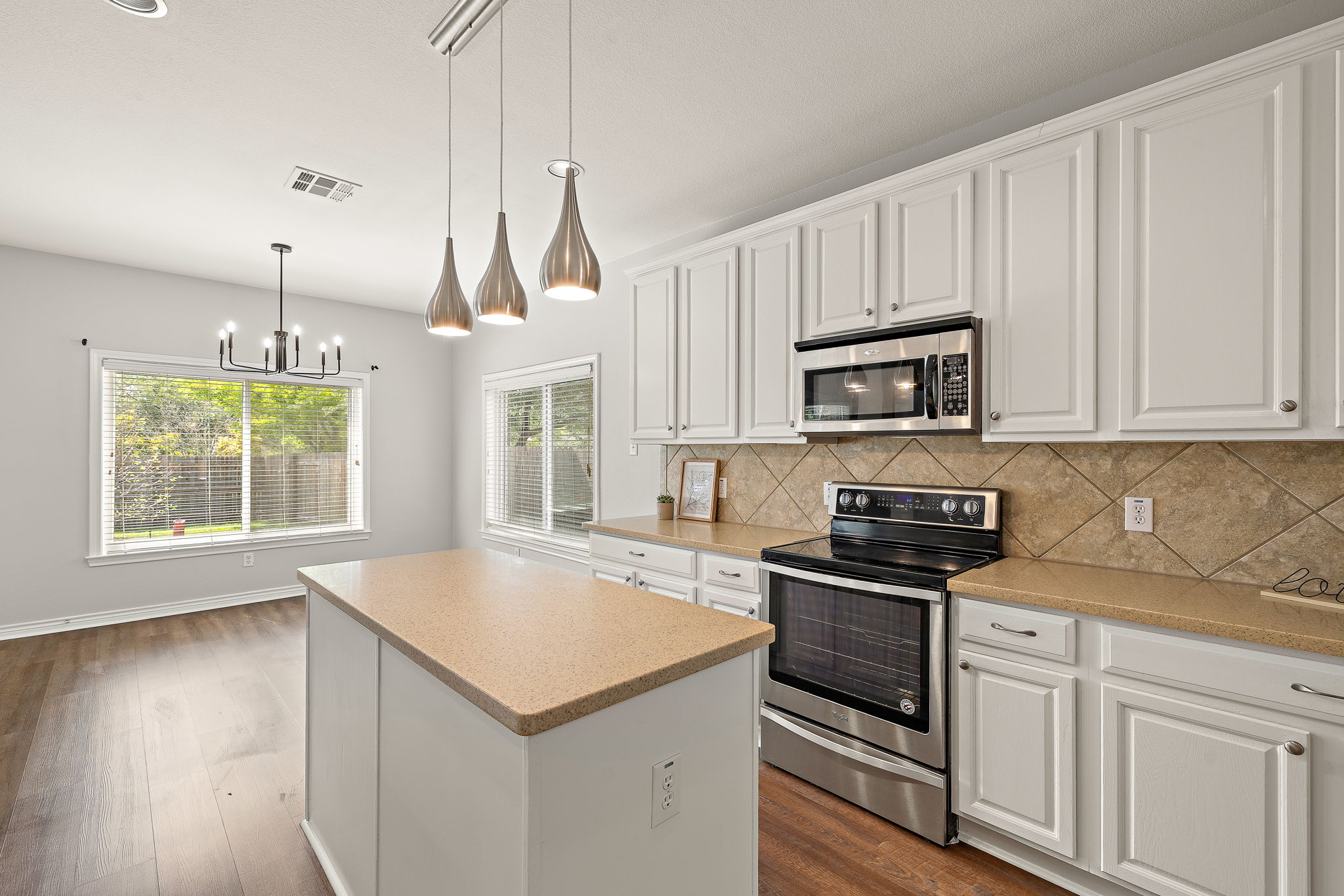 202 Nick Price Loop Round Rock, TX 78664 - Photo 15 of 39 a kitchen with granite countertop white cabinets and white appliances