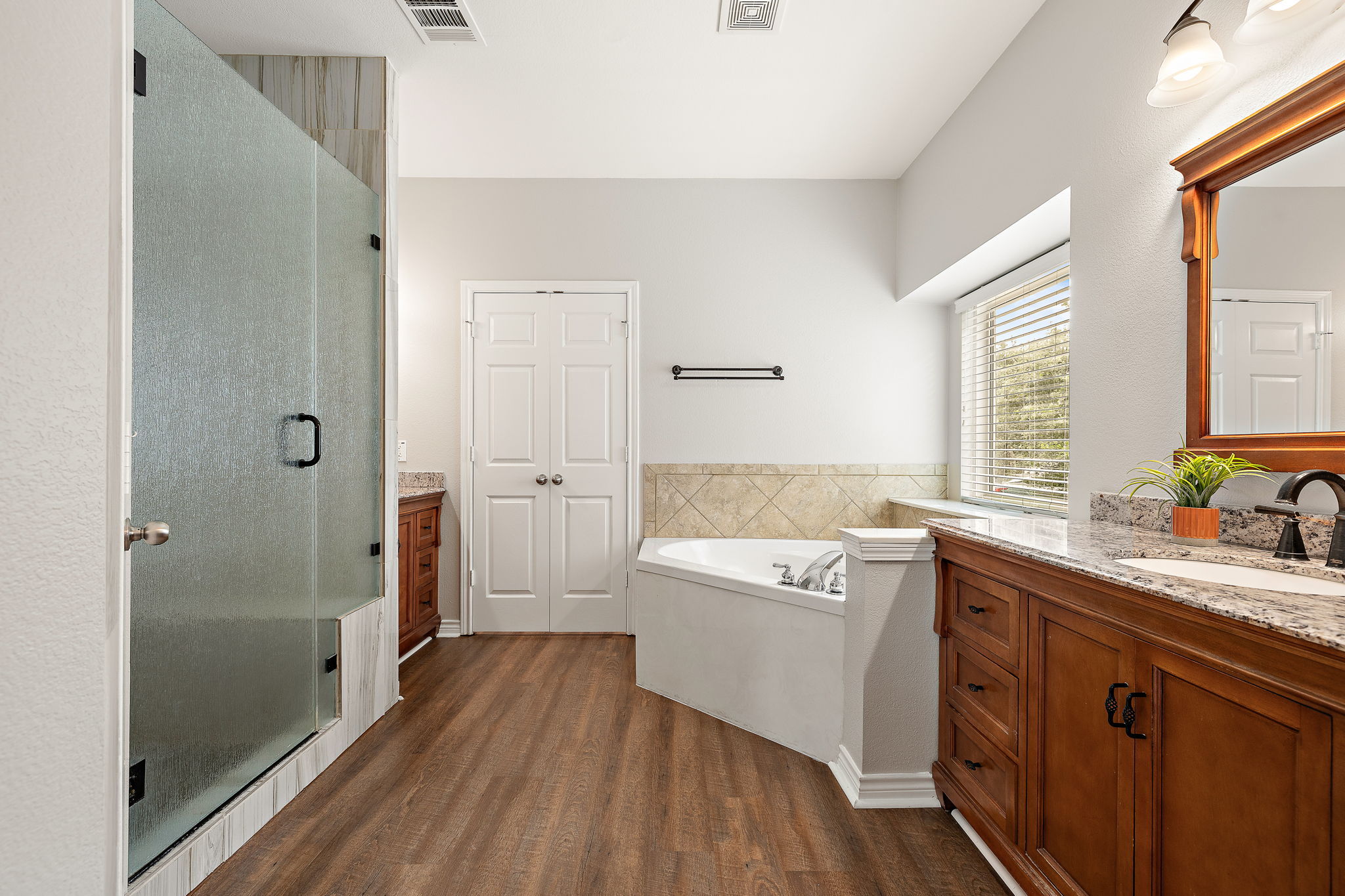 202 Nick Price Loop Round Rock, TX 78664 - Photo 17 of 39 a spacious bathroom with a granite countertop sink a toilet a shower and a mirror