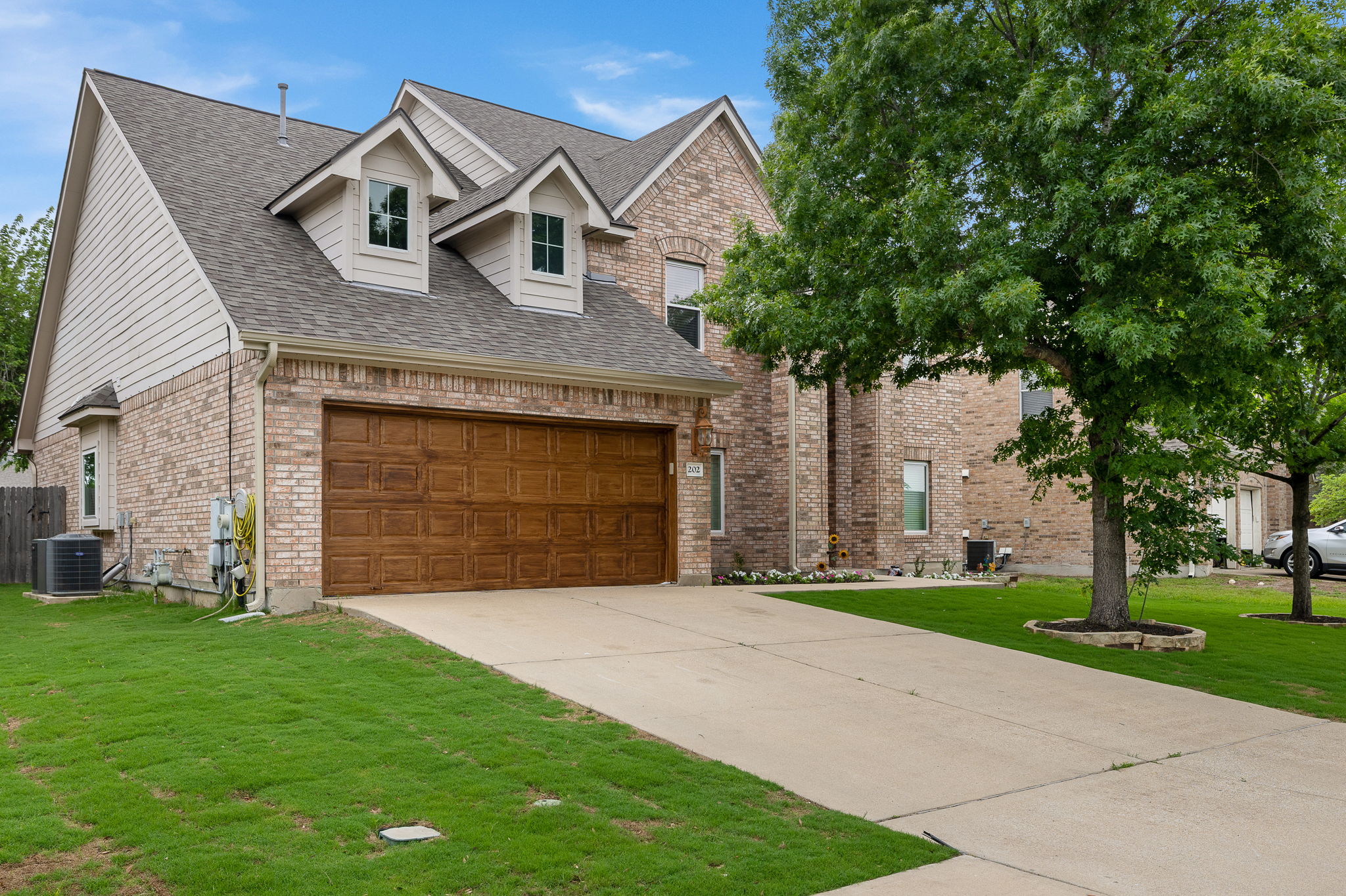202 Nick Price Loop Round Rock, TX 78664 - Photo 2 of 39 a front view of a house with a garden and yard