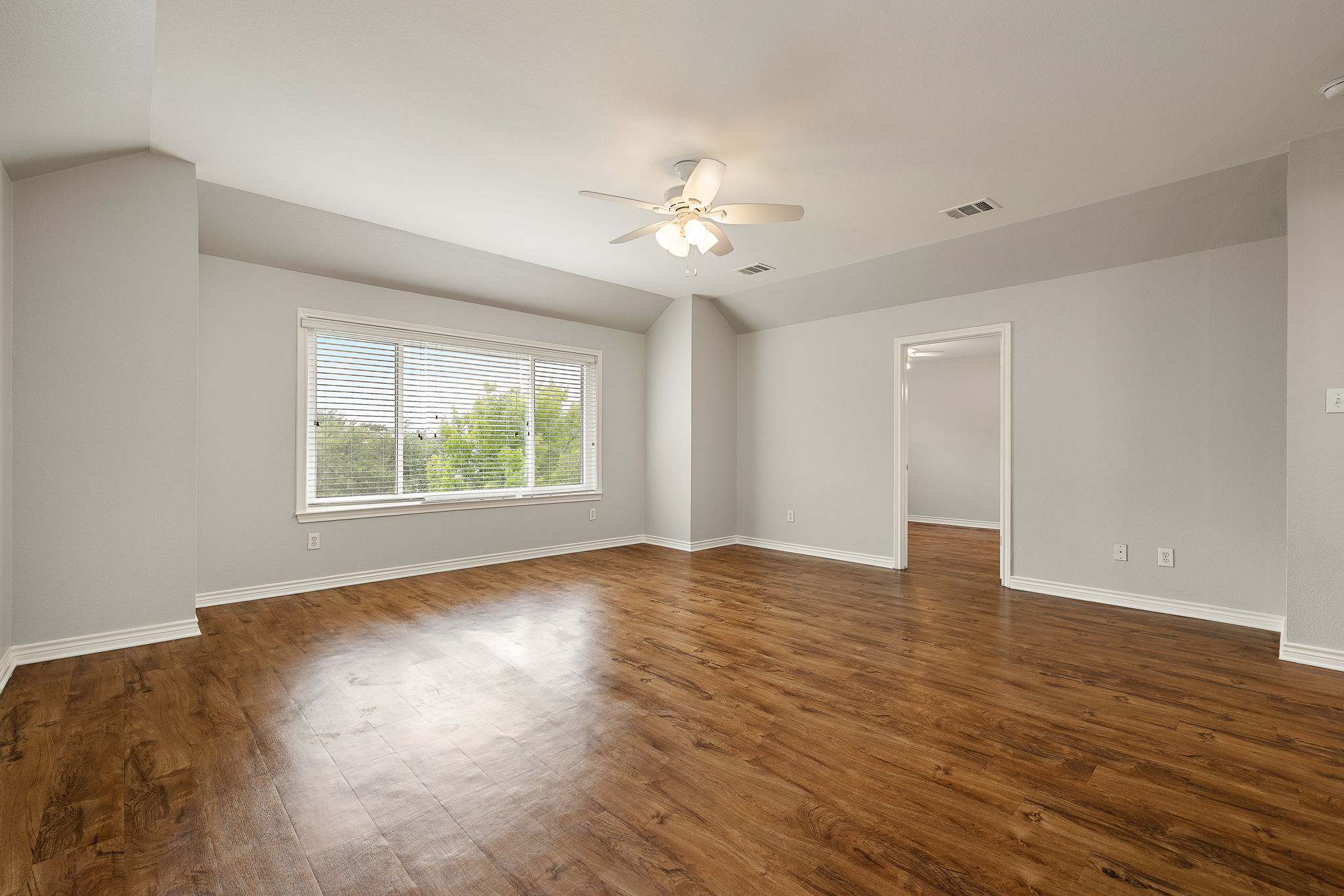 202 Nick Price Loop Round Rock, TX 78664 - Photo 22 of 39 a view of an empty room with wooden floor and a window