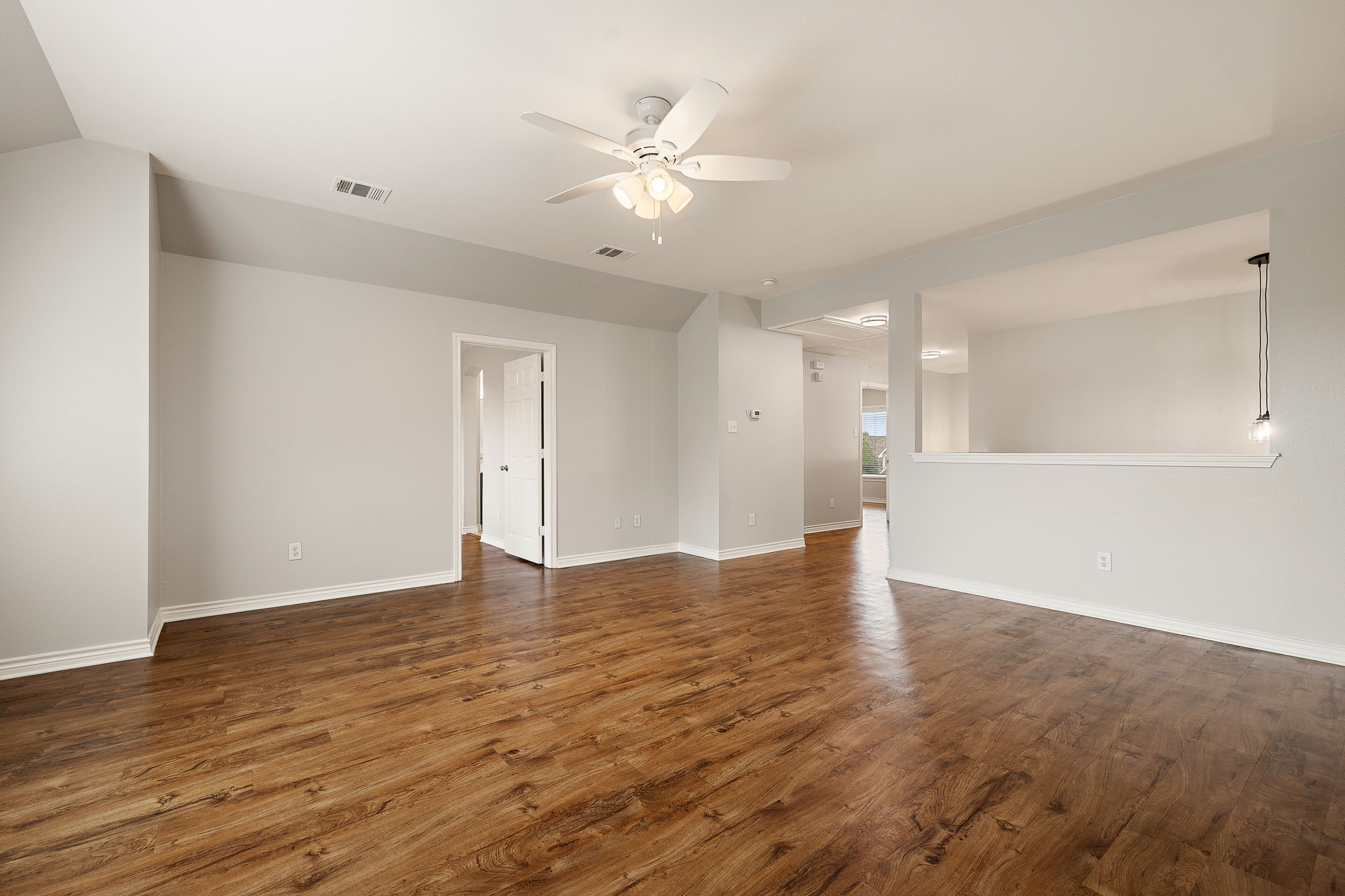 202 Nick Price Loop Round Rock, TX 78664 - Photo 23 of 39 a view of an empty room with wooden floor and a ceiling fan