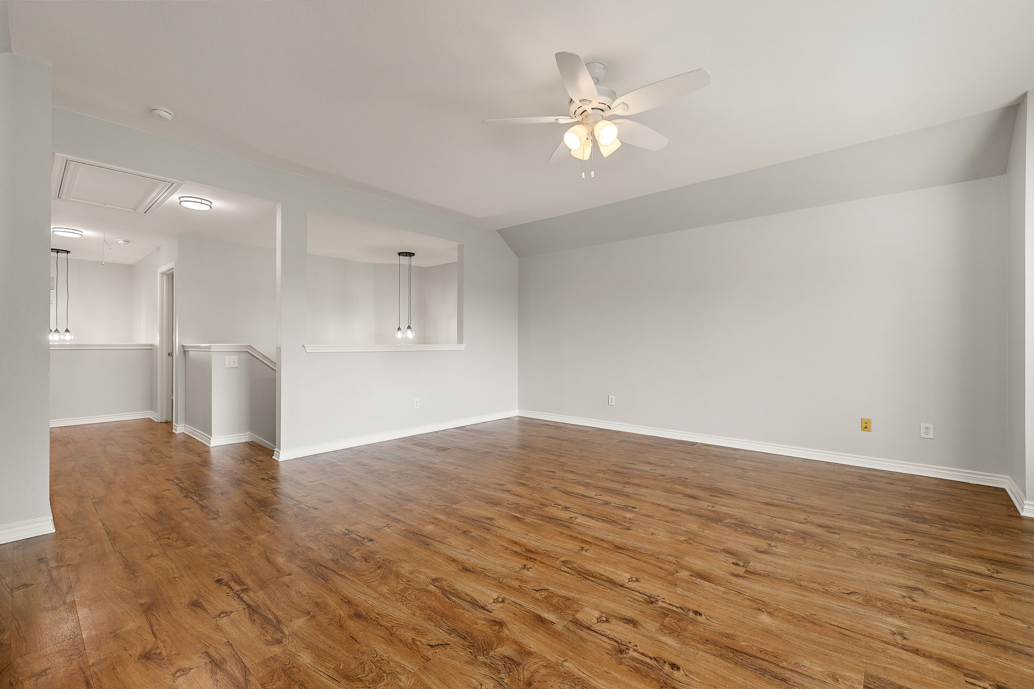 202 Nick Price Loop Round Rock, TX 78664 - Photo 24 of 39 a view of an empty room with wooden floor and a kitchen