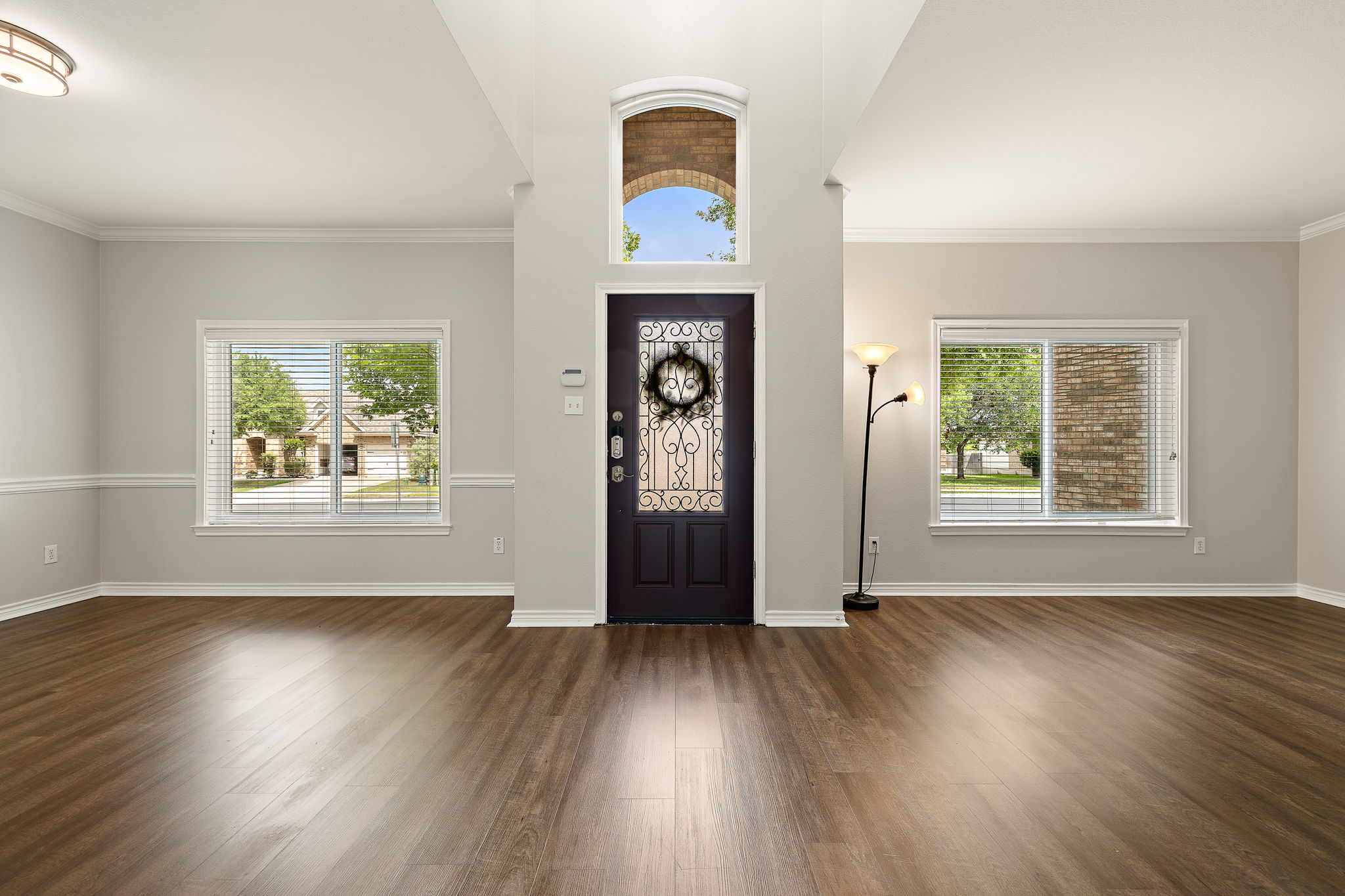 202 Nick Price Loop Round Rock, TX 78664 - Photo 4 of 39 an empty room with wooden floor window and windows