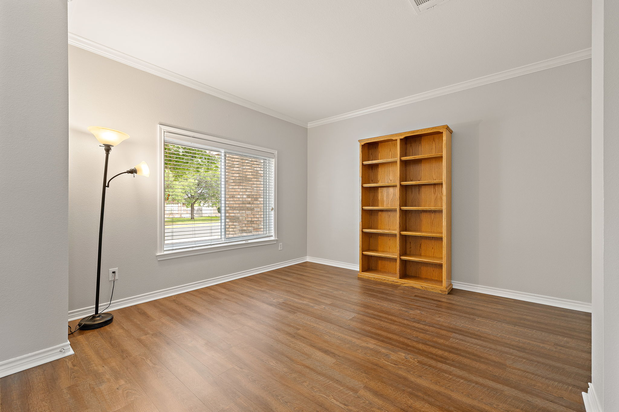 202 Nick Price Loop Round Rock, TX 78664 - Photo 5 of 39 an empty room with wooden floor cabinet and windows