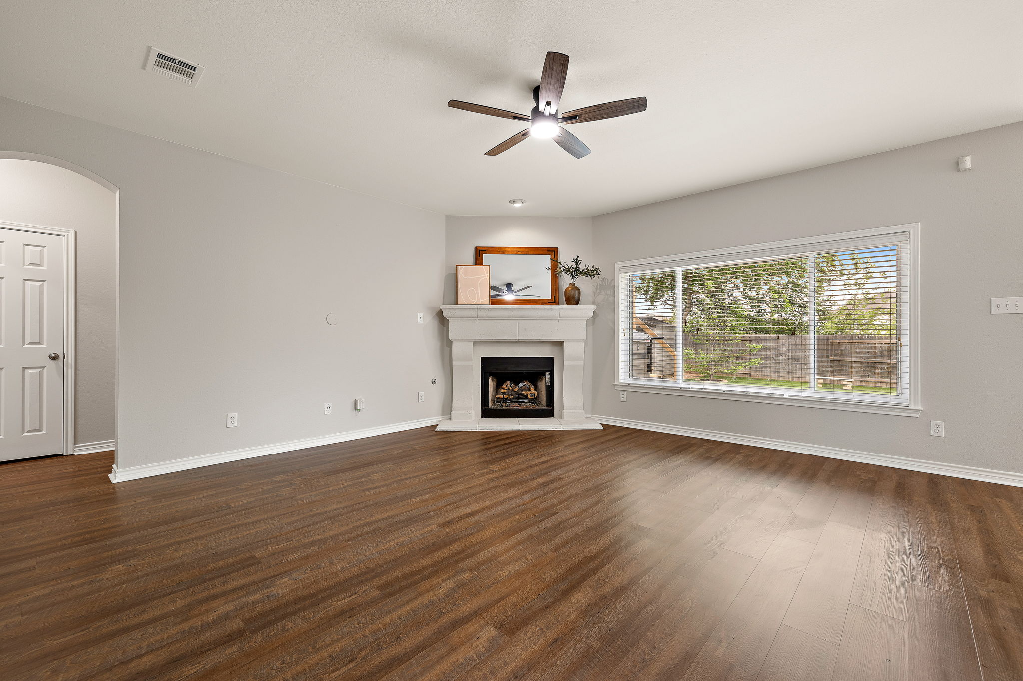 202 Nick Price Loop Round Rock, TX 78664 - Photo 8 of 39 an empty room with wooden floor fireplace and windows