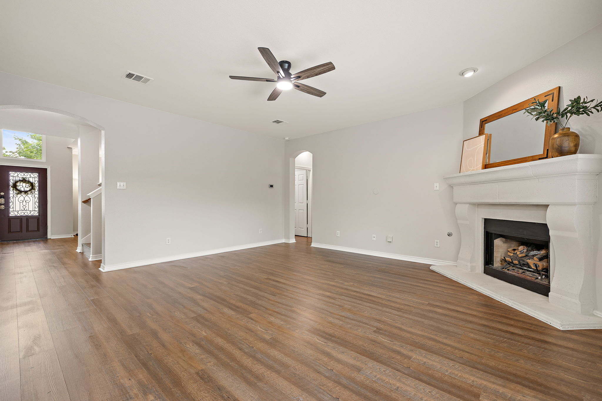 202 Nick Price Loop Round Rock, TX 78664 - Photo 9 of 39 a view of empty room with wooden floor and fireplace
