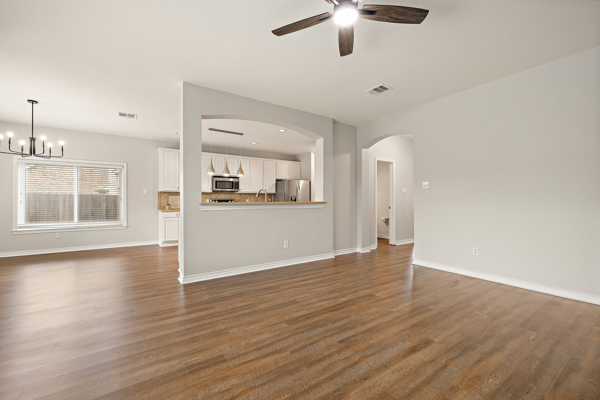 202 Nick Price Loop Round Rock, TX 78664 - Photo 10 of 39 wooden floor in an empty room with a window