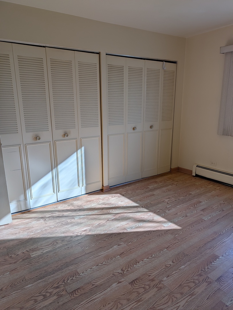 8444 West Wilson Avenue, Unit 407 Chicago, IL 60656 - Photo 7 of 20 a view of a livingroom with wooden floor
