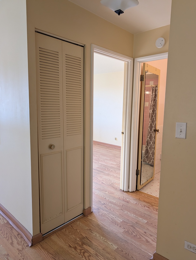 8444 West Wilson Avenue, Unit 407 Chicago, IL 60656 - Photo 10 of 20 an empty room with wooden floor and a window
