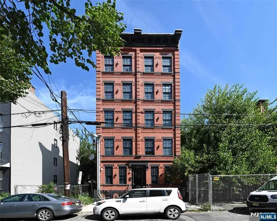 a front view of a building with parking space
