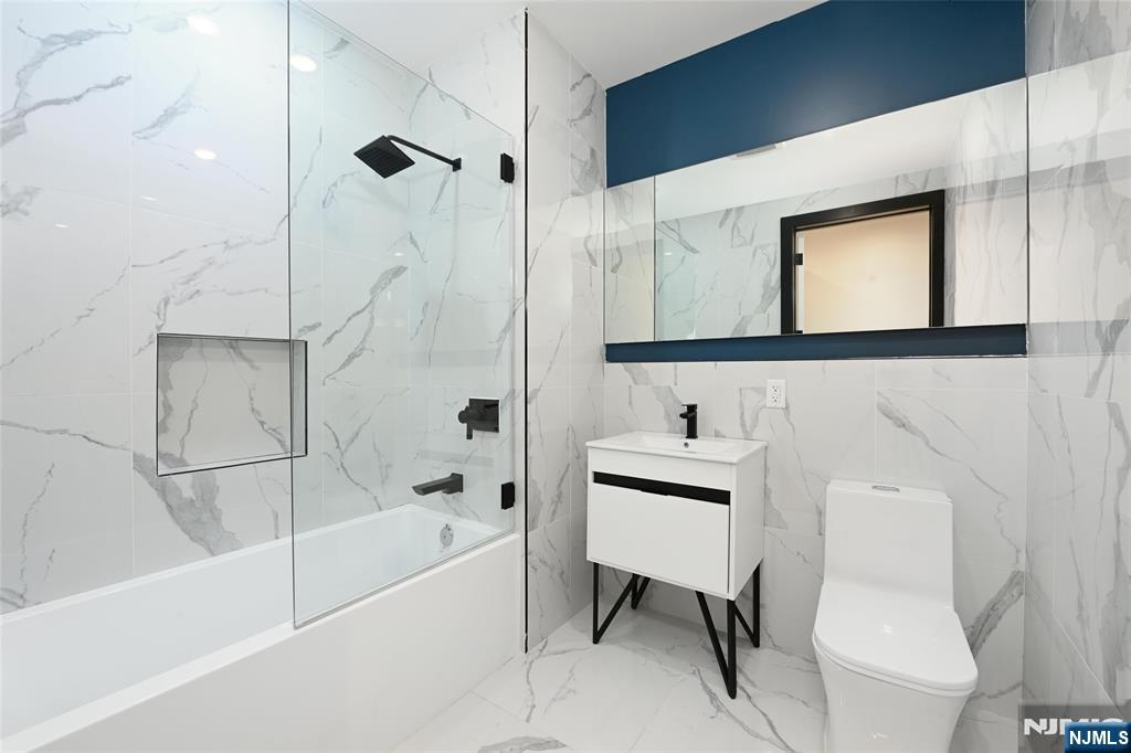 208 15th Street Jersey City, NJ 07310 - Photo 15 of 46 a bathroom with a sink a toilet and a bathtub
