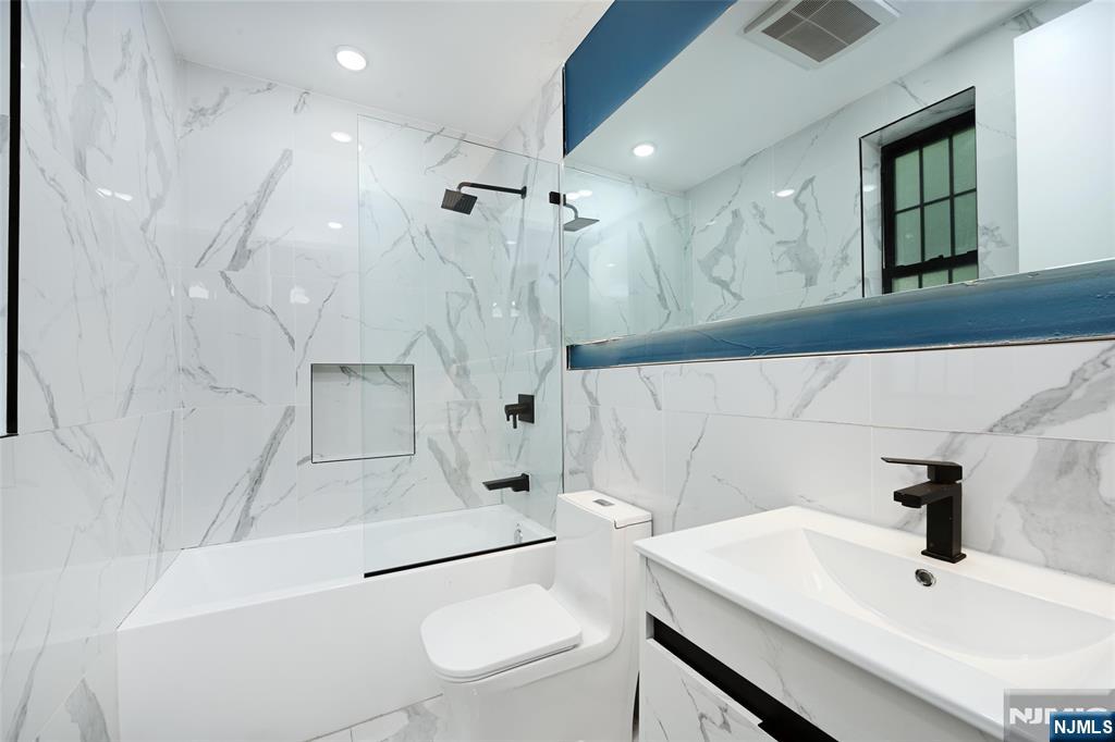 208 15th Street Jersey City, NJ 07310 - Photo 18 of 46 a bathroom with a sink a toilet and shower