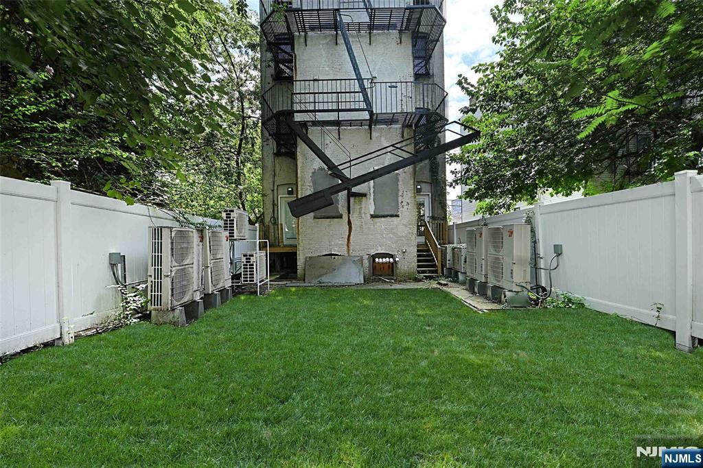 208 15th Street Jersey City, NJ 07310 - Photo 21 of 46 a backyard of a house with table and chairs